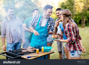 stock-photo-friends-having-a-barbecue-party-in-nature-while-having-a-blast-443830165