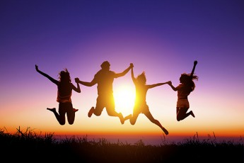 group of happy young people jumping on the mountain